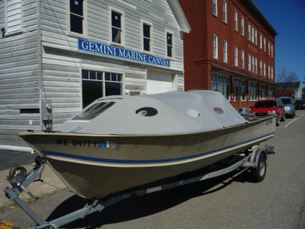 Boat with unique bow cover outside Gemini Marine Canvas. 